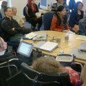 A group of students and AAC users during a group meeting